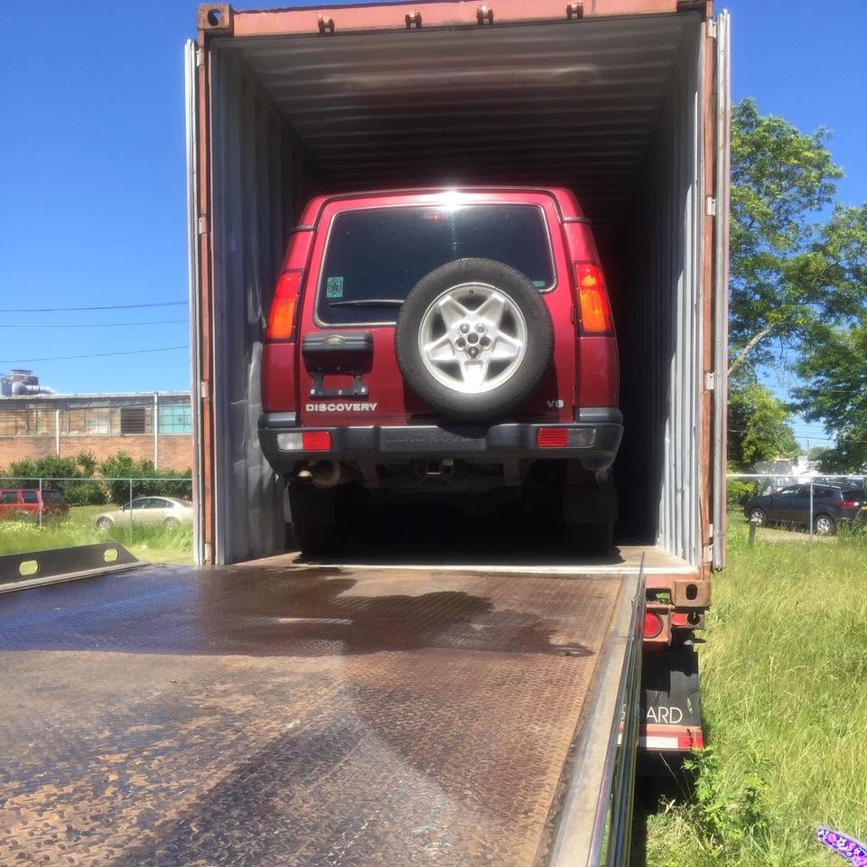 Vehicle loaded into a shipping container from a JMB Towing flatbed